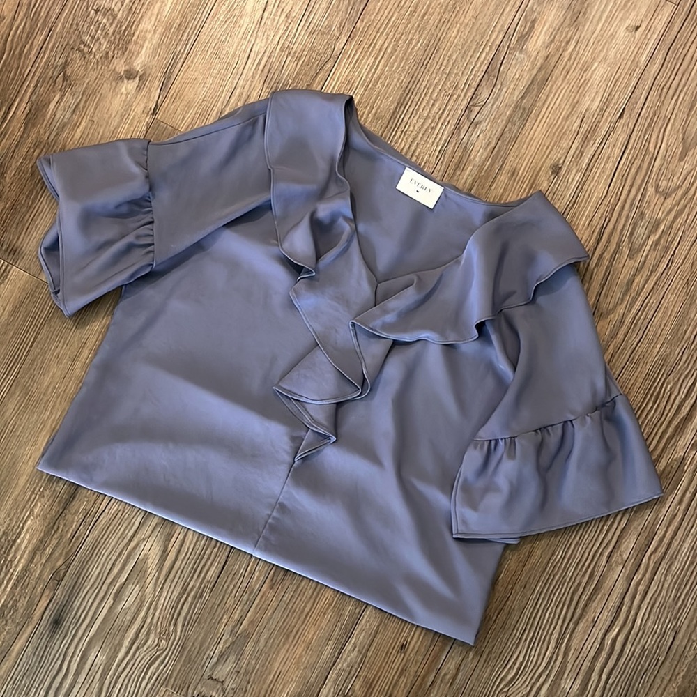 Size SMALL blouse with elegant ruffle detail.